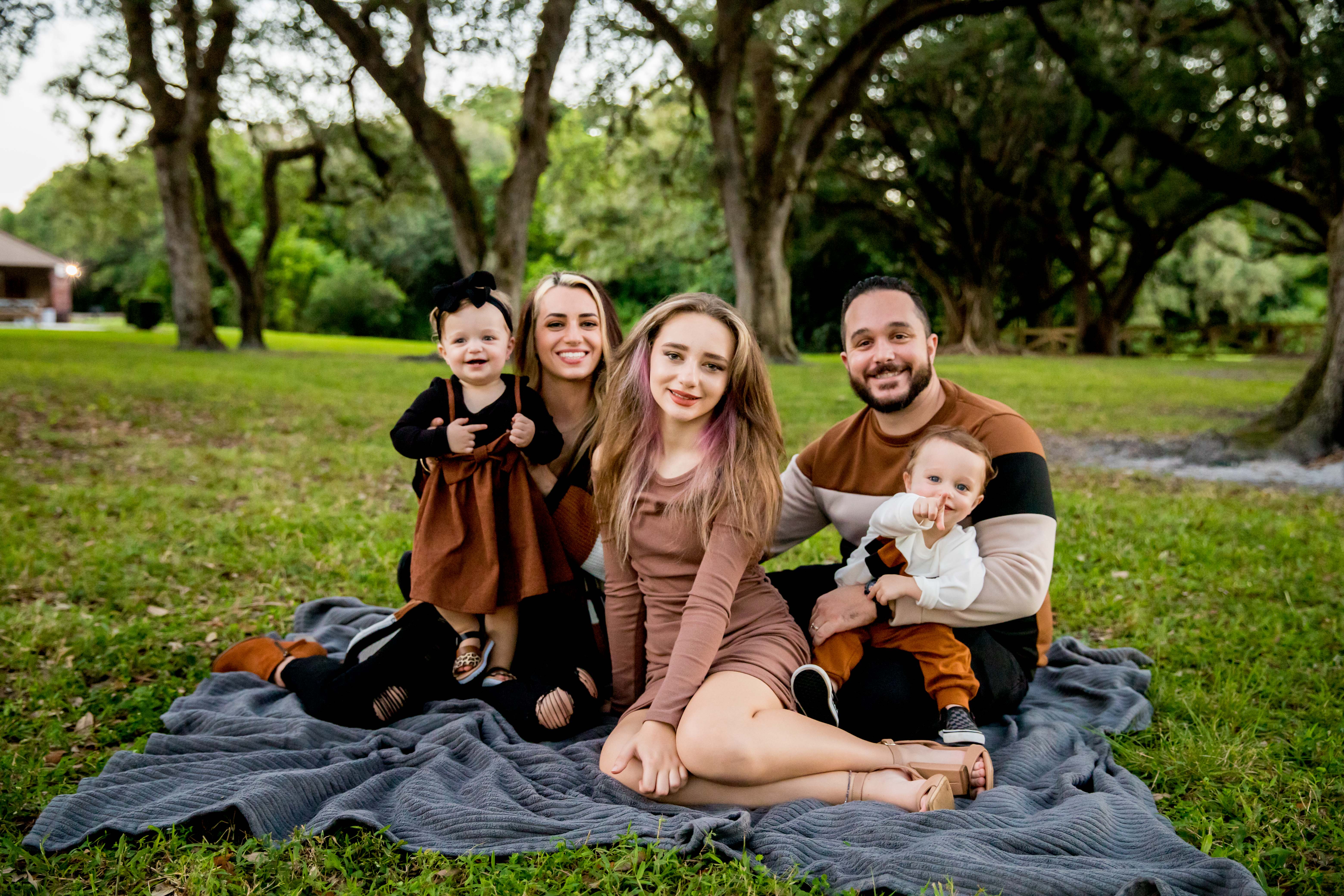Verklas family relaxing together outdoors on a blanket, demonstrating close family bonds and personal life values